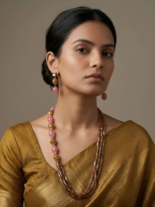 Layered pink jade necklace featuring gold-tone Pacchi beads, pastel green accents and elongated bead strands, paired with matching earrings for weddings