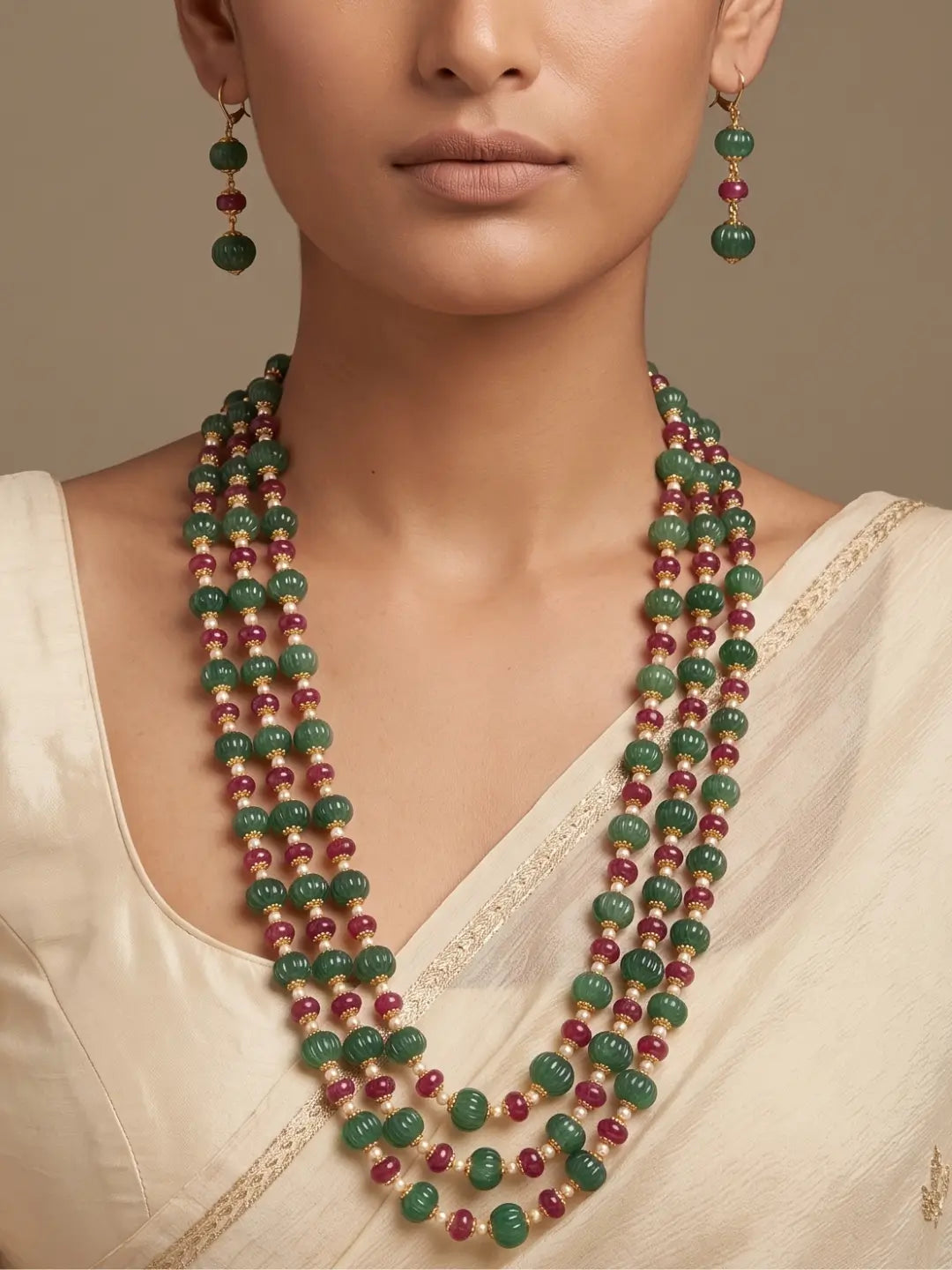 Layered ruby red and green jade beaded necklace set with pearl spacers and matching earrings for Indian weddings and festive occasions.