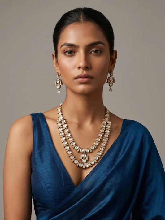Layered white Polki necklace and earrings featuring oval stone motifs, contemporary geometric gold accents and a refined silhouette for celebrations