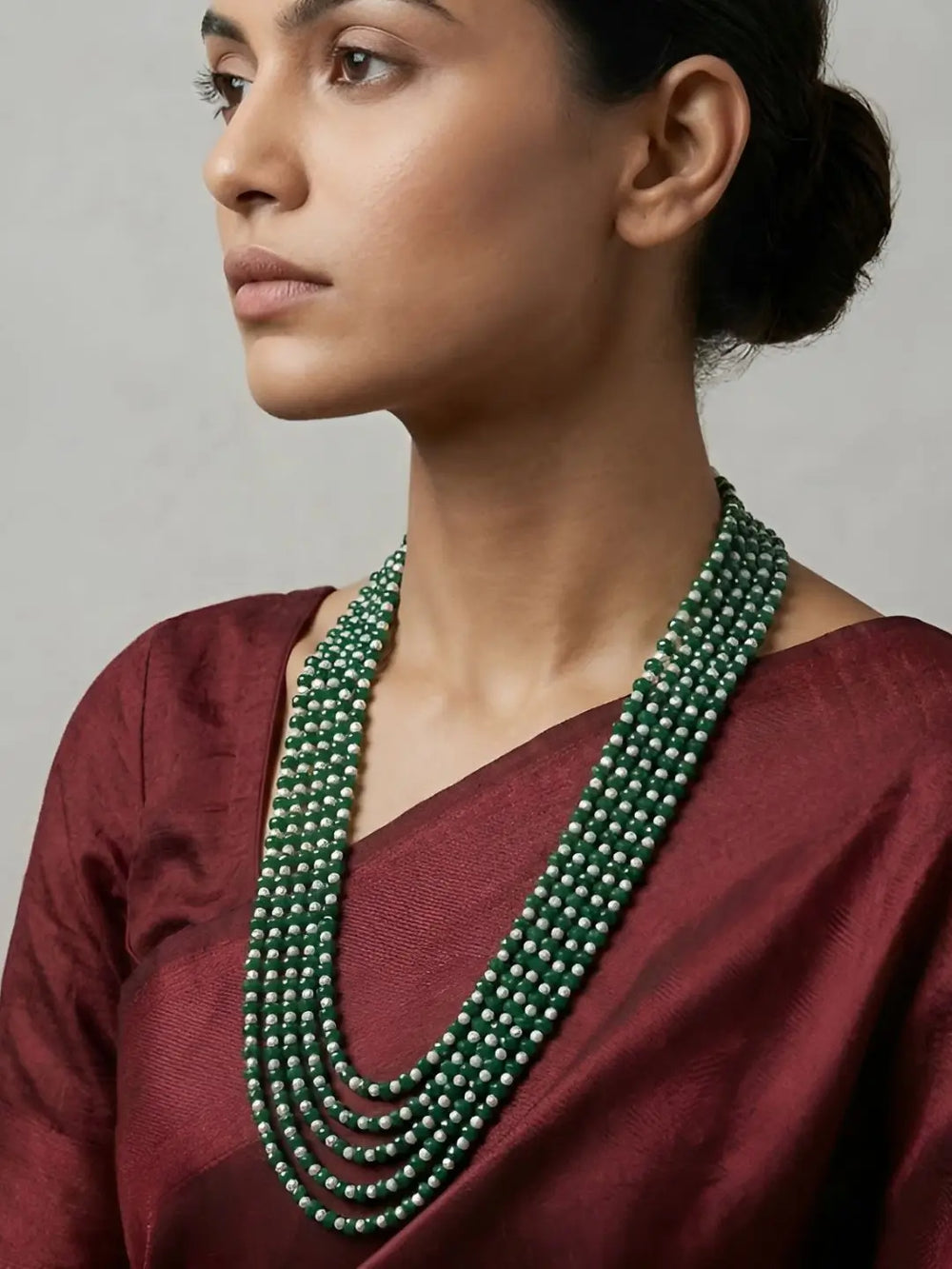 Long green jade and freshwater pearl necklace featuring multiple graduated strands for a layered ethnic jewellery look.