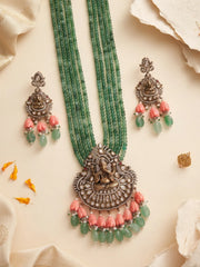Traditional green temple jewellery featuring a detailed Ganesha pendant, Kundan and Polki stone accents, multistrand beads and matching earrings.