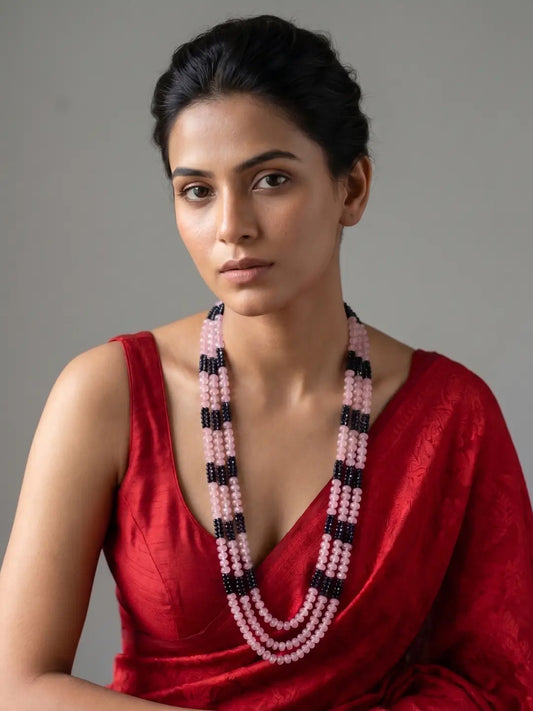 Long pink and blue beaded mala for women with gold plating, layered gemstone beads and shell pearls, styled with traditional Indian outfits.