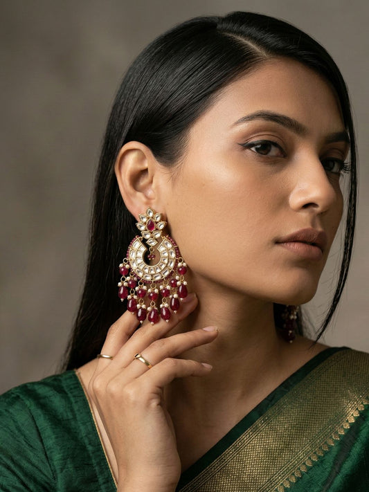Maroon gold plated Polki Chandbali earrings with Kundan stones, American diamond accents, pearl drops and gemstone beads.