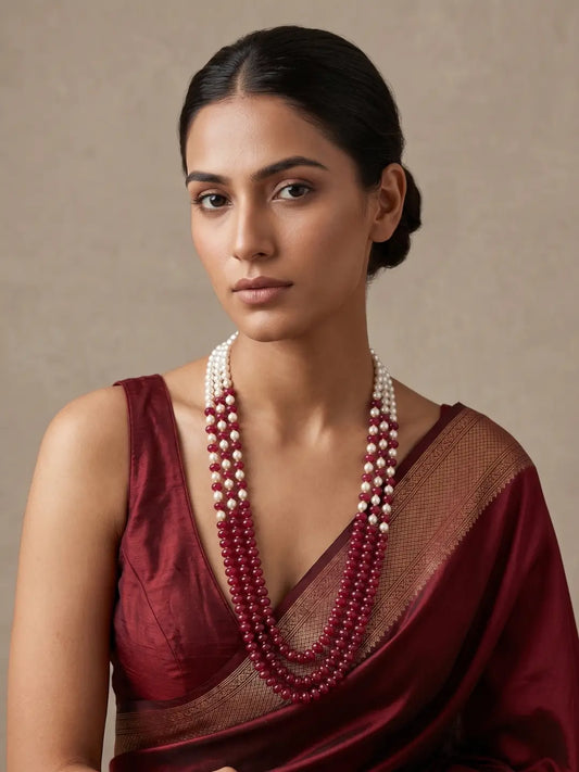 Maroon layered beaded mala with green and red jade beads, shell pearls and gold-plated detailing, designed for weddings and festive ethnic outfits.