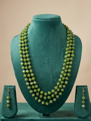 Pair of drop earrings with coordinated green cube beads hanging from gold-toned hooks, shown as the matching piece of the necklace set