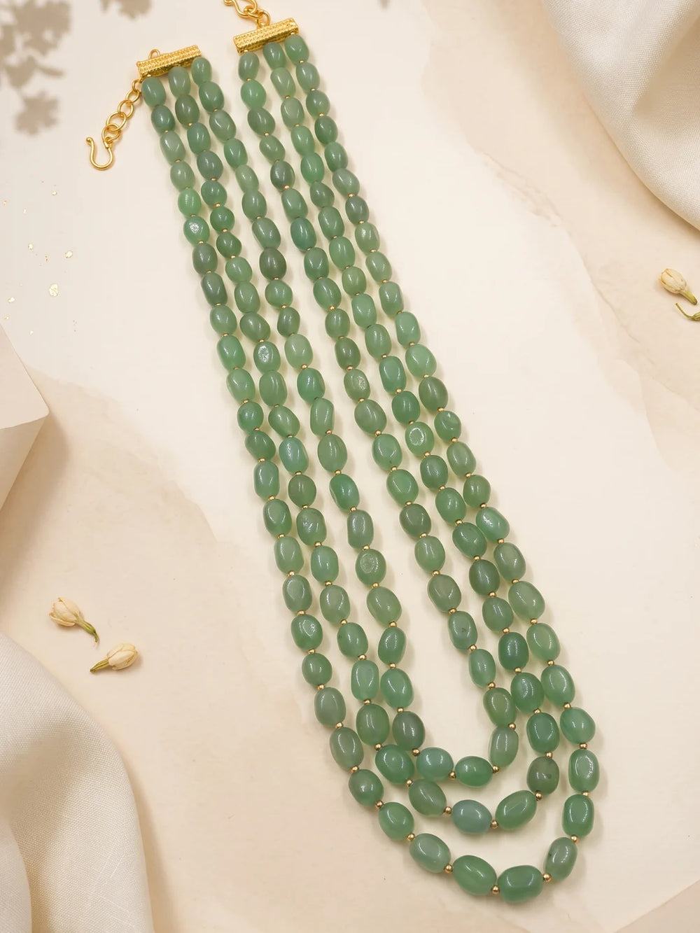 Long mint green sherwani mala featuring multiple strands of polished green jade beads arranged in a cascading design for wedding attire.