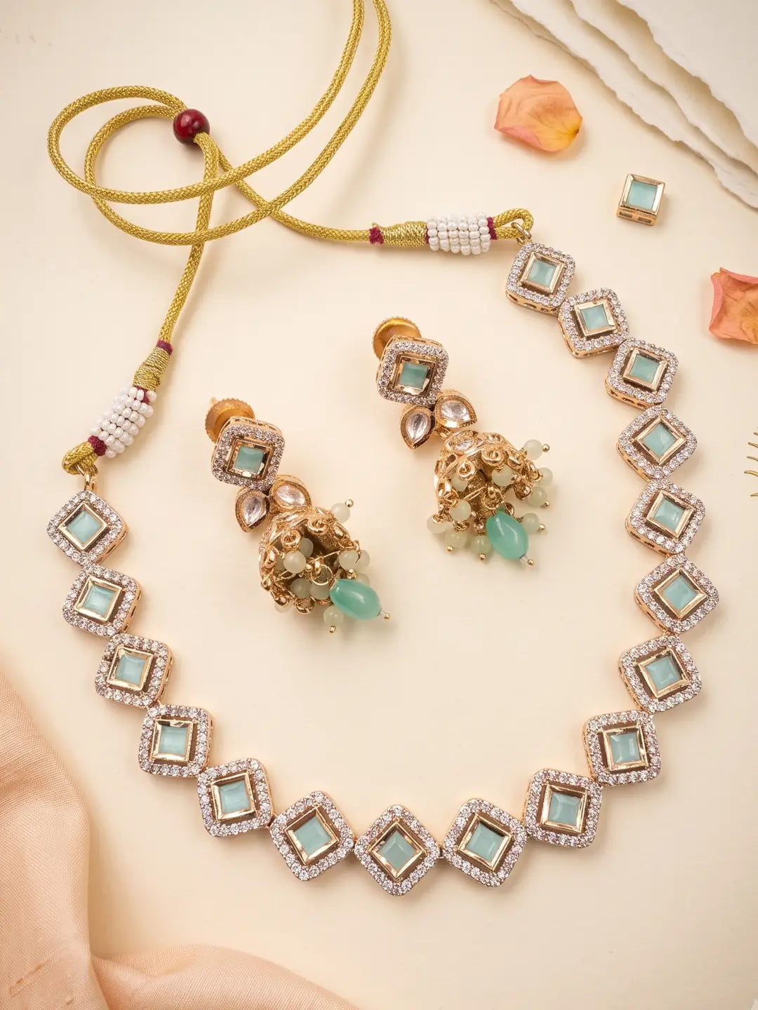 Mint green CZ and Polki necklace set with matching jhumka earrings, suitable for weddings, mehendi, sangeet and festive celebrations.