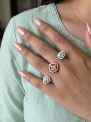 Mint green CZ Polki dual finger ring with two connected gold-tone bands, enamel detailing and ornate stonework for bridal and traditional occasions
