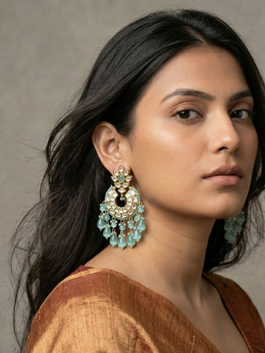 Mint green Kundan Polki Chandbali earrings with American diamond accents, faux pearls and gemstone beads in a gold-plated finish