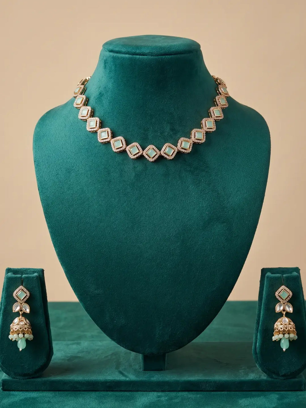 Mint green Polki and Kundan-style choker featuring CZ stones and matching jhumka earrings for traditional Indian outfits.