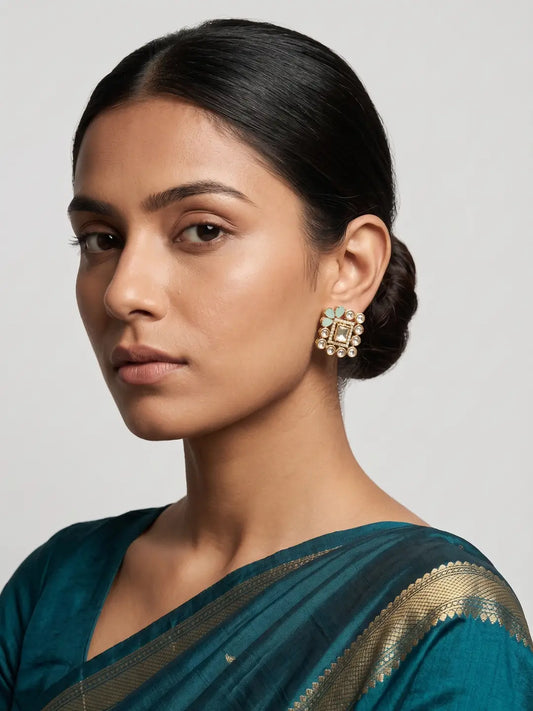 Mint green square polki stud earrings with soft floral stone accents, kundan details and gold plated finish for occasion wear