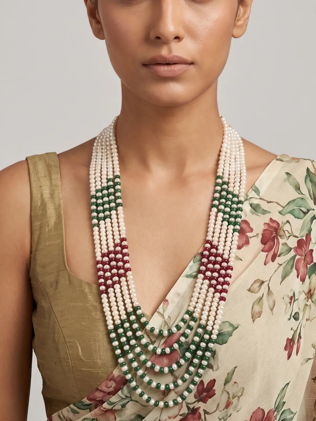 Long multi-strand necklace featuring natural white freshwater pearls, ruby red and green jade bead sections, and gold-plated detailing.