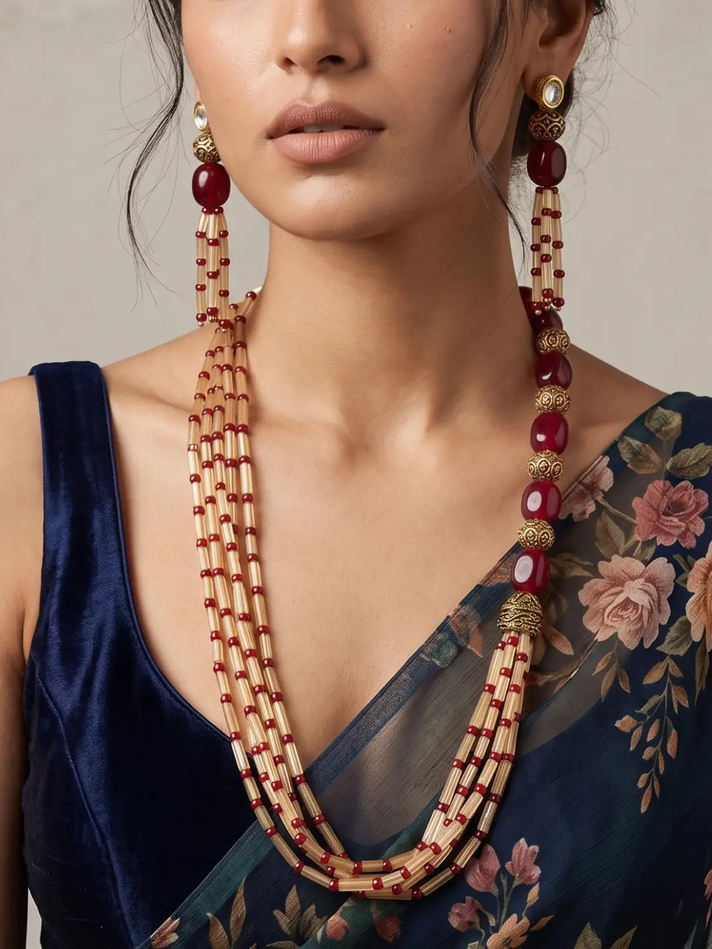 Layered red jade and brown fluorite beaded necklace set with gold-toned detailing, shown with matching earrings that echo the bead accents