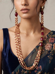 Layered red jade and brown fluorite beaded necklace set with gold-toned detailing, shown with matching earrings that echo the bead accents