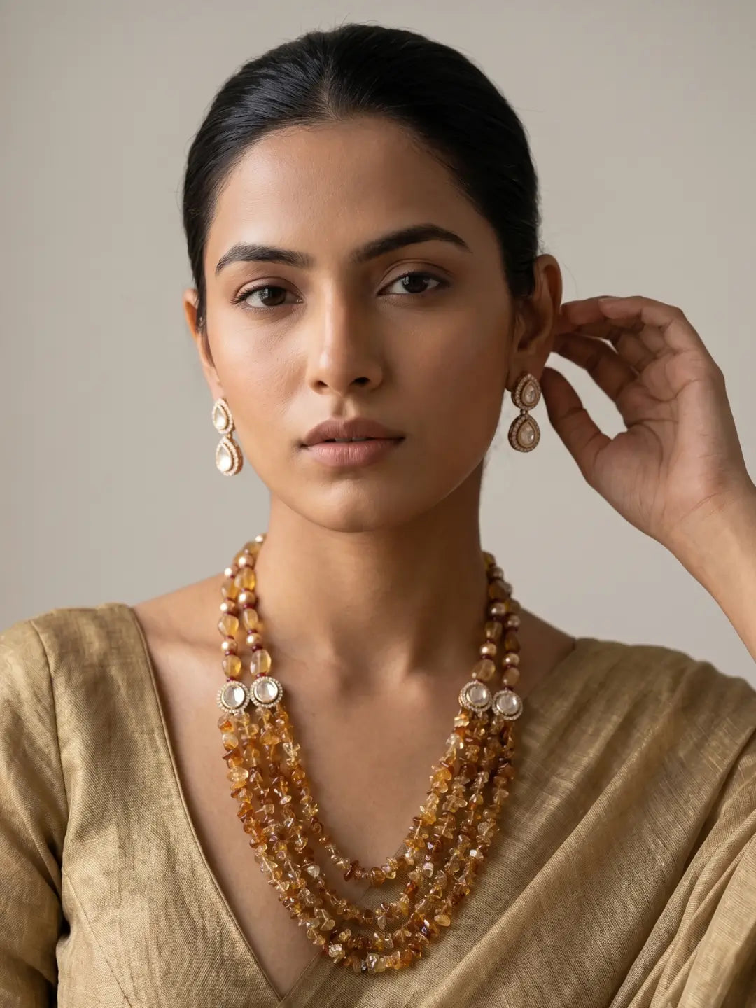Multi-strand yellow citrine beaded jewellery set with Kundan accents, Tanjore-painted pearls and matching earrings for traditional occasions.