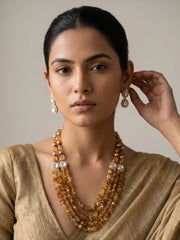 Multi-strand yellow citrine beaded jewellery set with Kundan accents, Tanjore-painted pearls and matching earrings for traditional occasions.