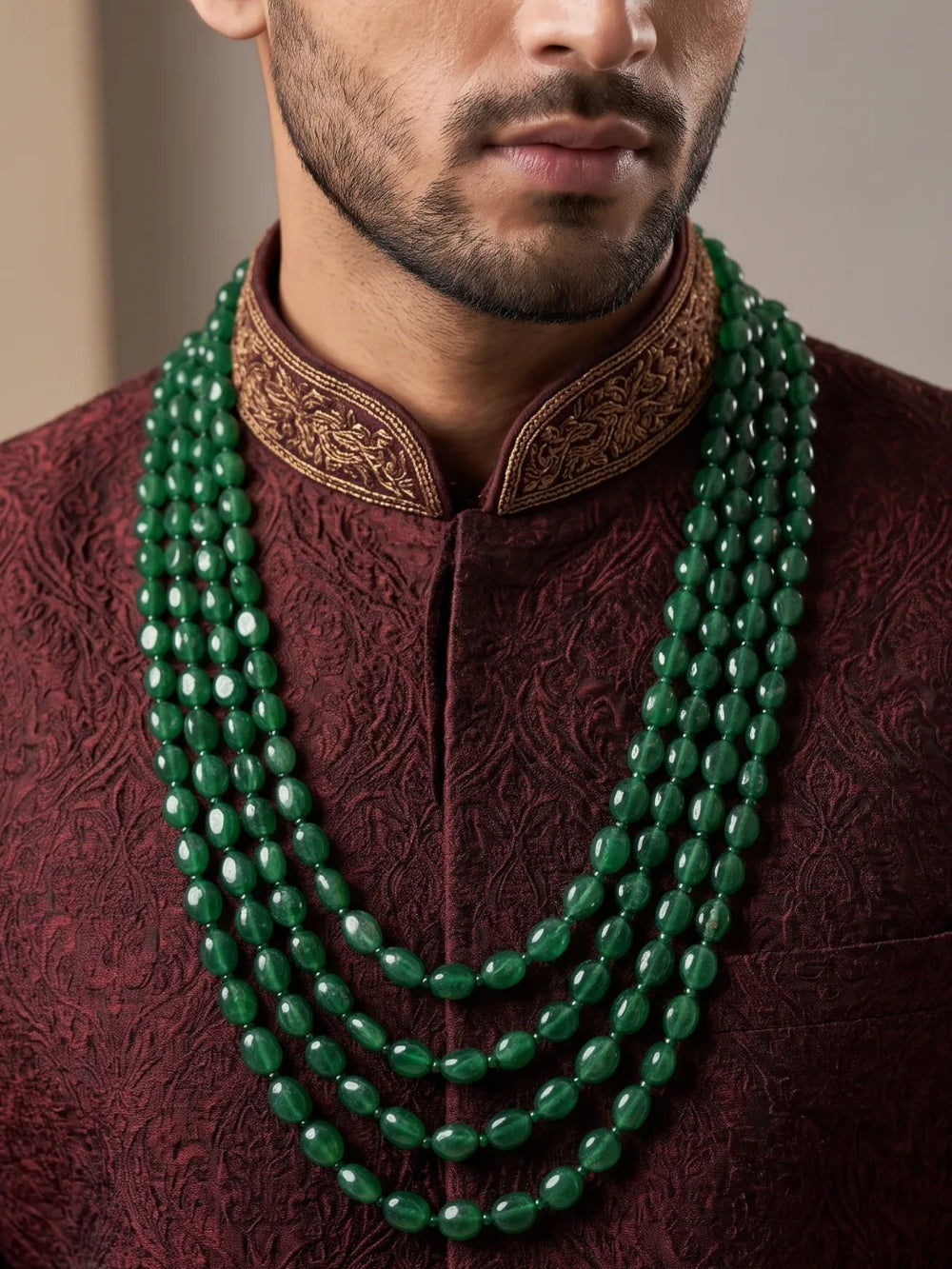 Traditional dulha mala featuring polished green jade beads in cascading strands with gold plating, designed to complement men's sherwanis for weddings.