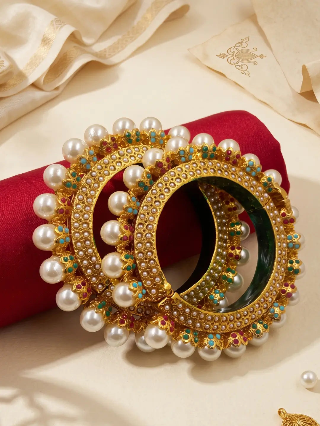 Multicolour gold plated Pearl Pacheli Jadau bangles with pink, green, blue and pearl accents, designed for weddings and festive ethnic outfits.