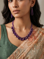 Purple amethyst beaded necklace set with faceted teardrop beads and layered strands of smaller amethyst beads, shown with matching multi-drop earrings