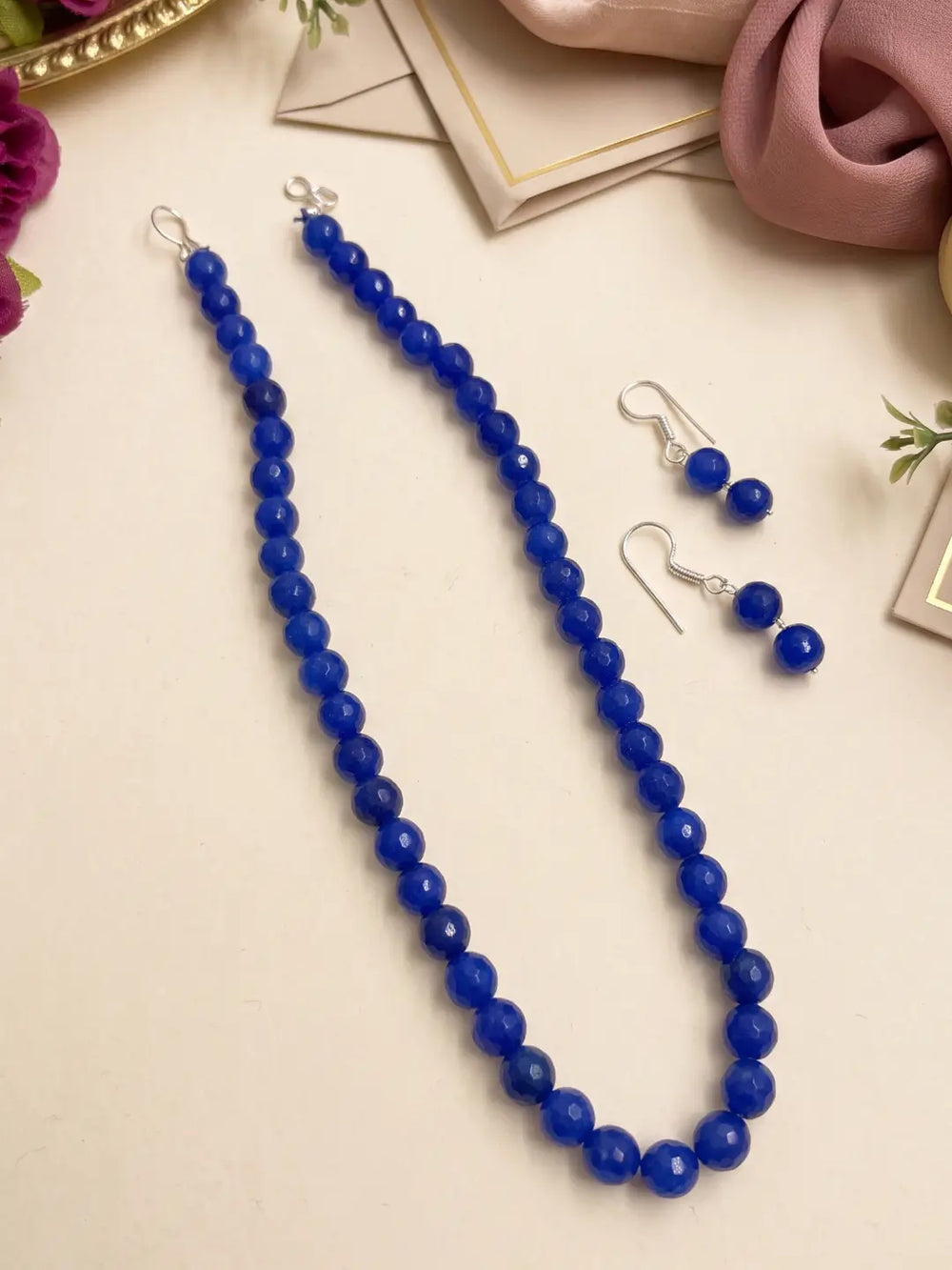 Single-strand navy faceted round jade bead mala necklace shown with matching drop earrings and silver-tone accents