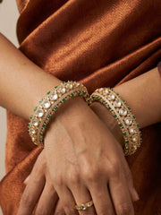 Openable pair of green and gold bangles decorated with Kundan, Polki, imitation emerald and CZ stones
