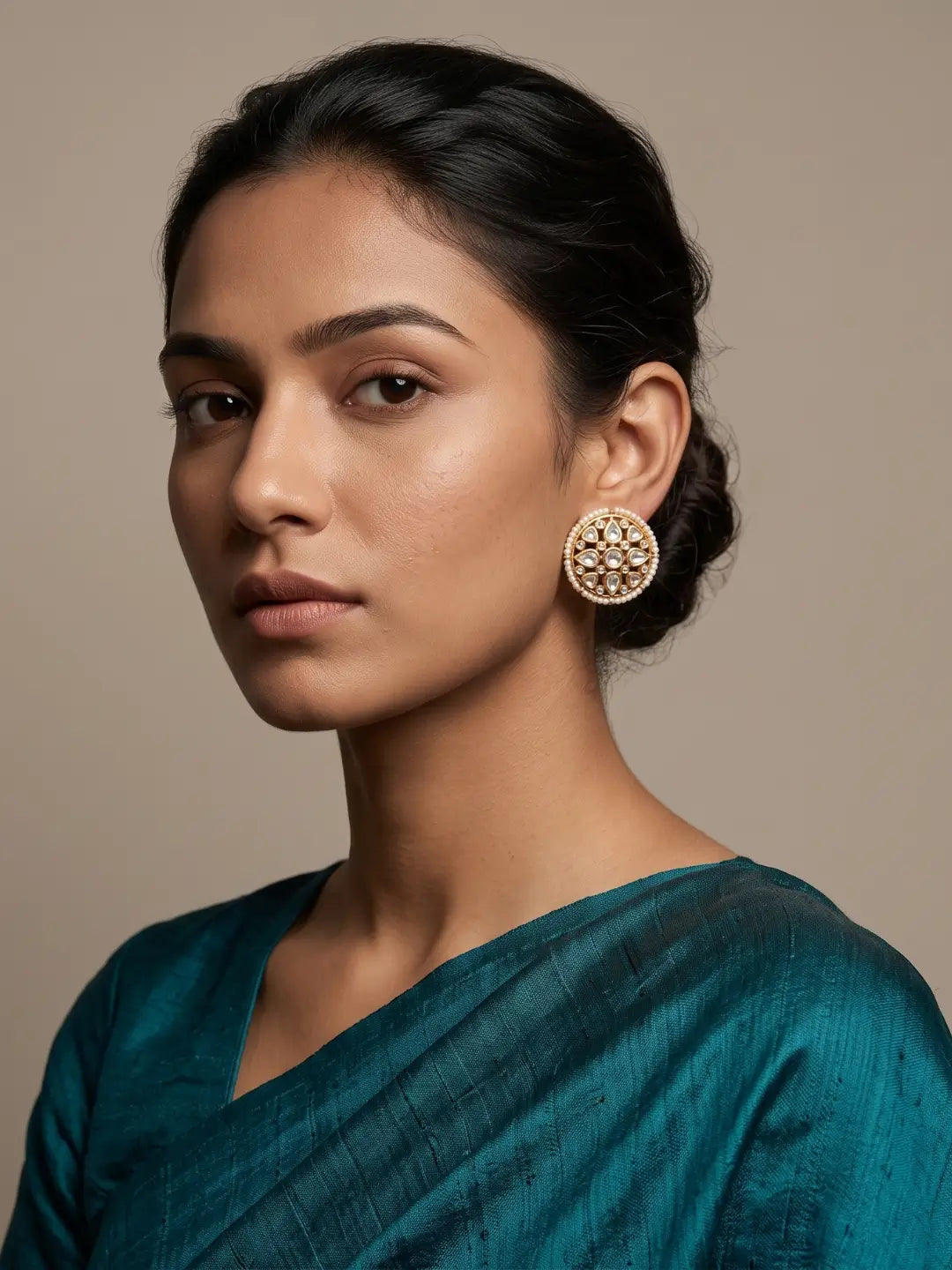 Oversized round Kundan earrings with luminous pearl border, floral-inspired CZ and Polki stone detailing in a gold plated setting
