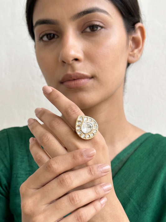 Pear shape Polki ring with Kundan stones surrounding the centre, warm gold-tone detailing and a graceful teardrop silhouette for bridal outfits