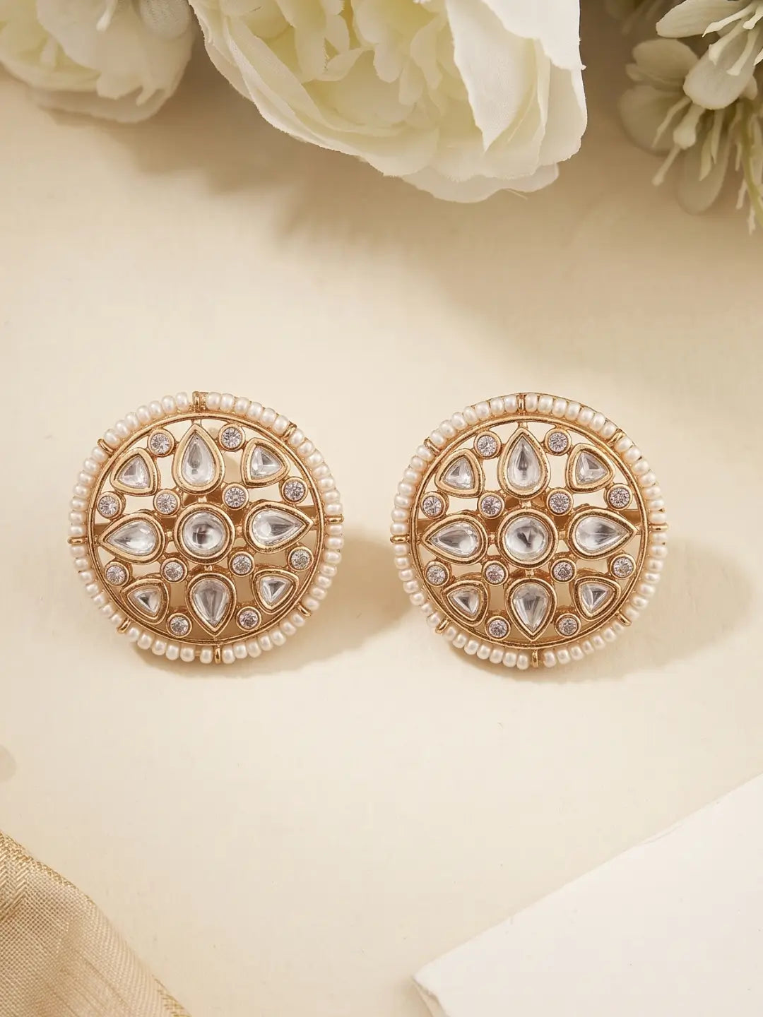 Round gold plated Kundan studs with pearl-edged border, floral stone arrangement and sparkling CZ details for weddings and festive occasions