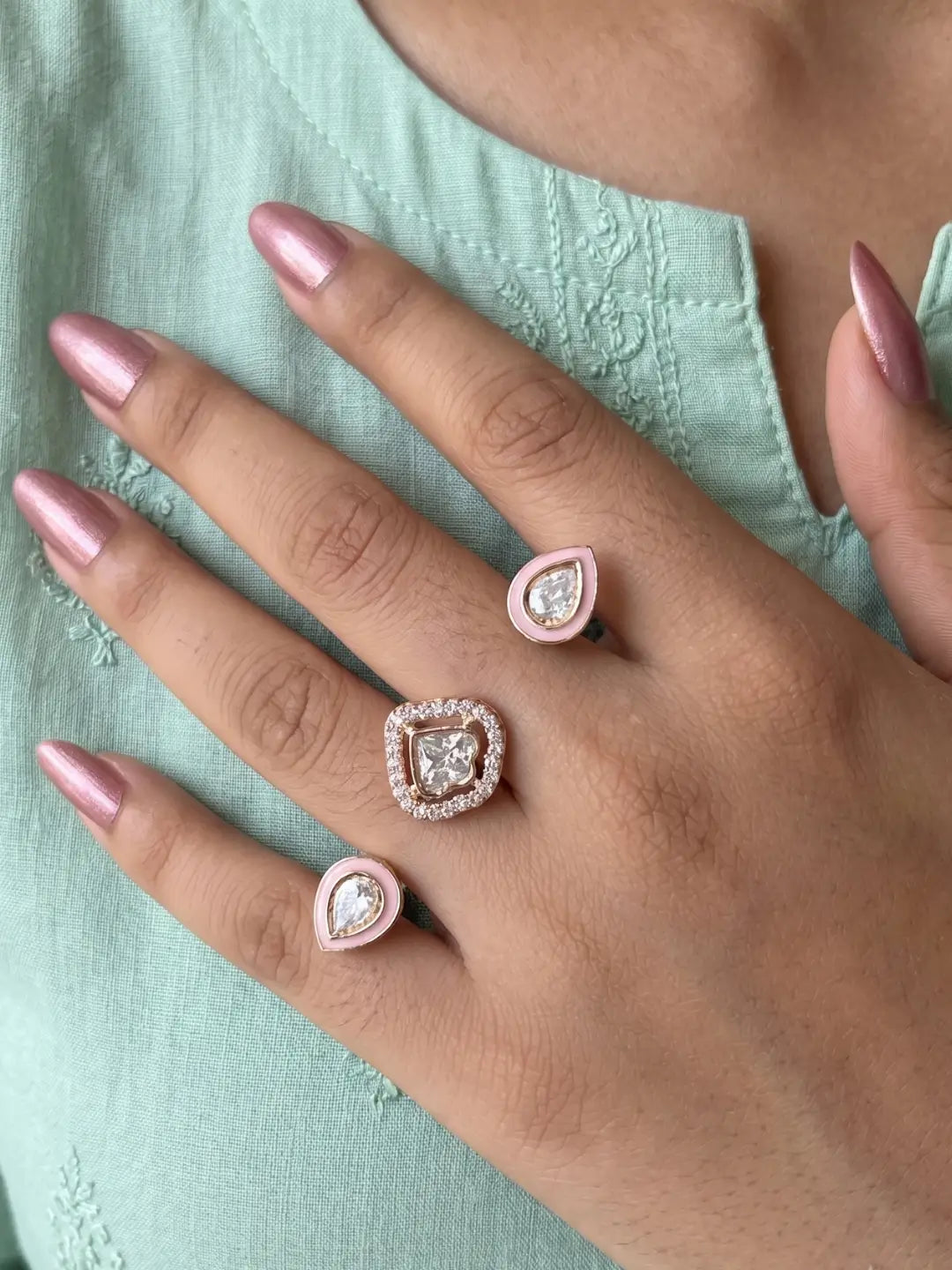 Pink CZ Polki dual finger ring with two gold-tone bands, connected stone elements and enamel detailing, suited to wedding, Sangeet and festive styling
