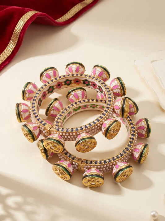 Pink and green floral Meenakari Kundan Pacheli bangles with ivory accents, pearl detailing and a gold-plated base for traditional styling.