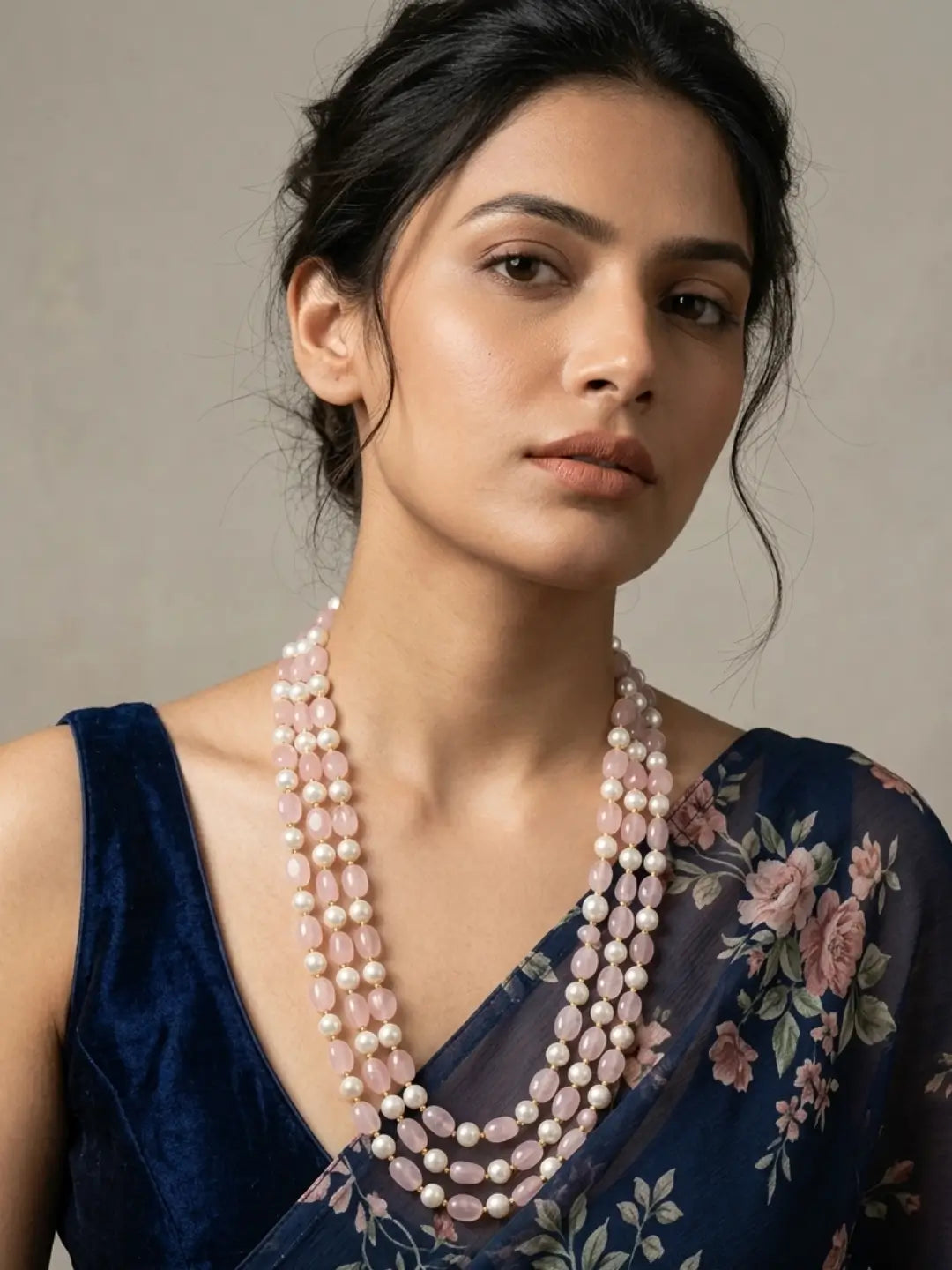 Triple-layer mala necklace with alternating pink jade beads and faux pearl beads in graduated strands and gold-plated detailing