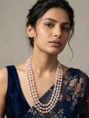 Triple-layer mala necklace with alternating pink jade beads and faux pearl beads in graduated strands and gold-plated detailing