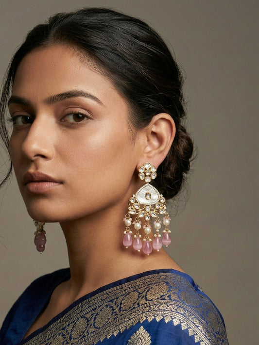 Pink gold plated Kundan earrings with a mother of pearl centre, floral stonework and multiple pearl danglers for bridal and festive styling.