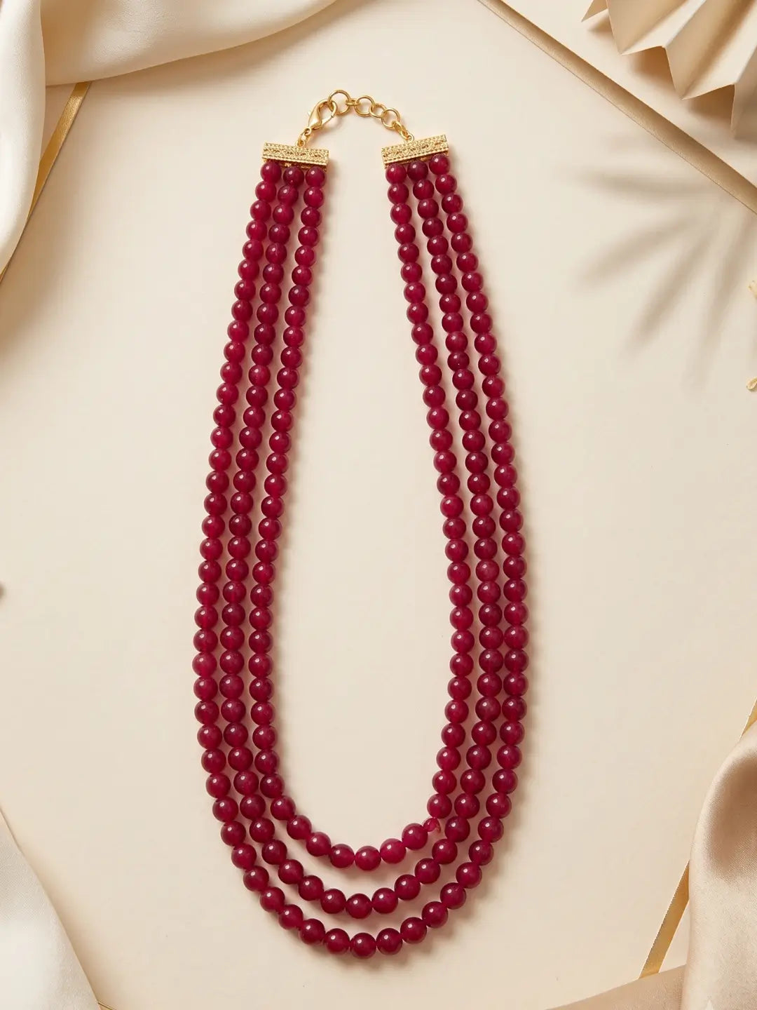 Layered red coral beaded necklace with gold-plated detailing, suited to styling with sarees, lehengas, Anarkalis and Indo-Western outfits