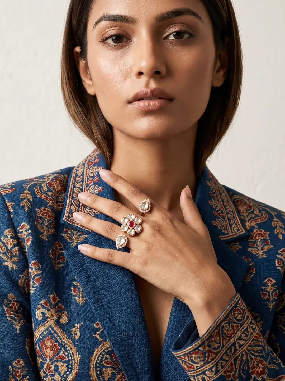 Red floral Polki double finger ring with gold plated finish, pear-shaped motifs, CZ detailing and an open dual-finger design for festive looks