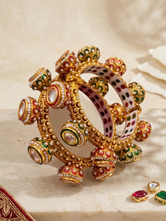 Red and green Meenakari Kundan Gokhru kada bangles featuring white pearl detailing, Kundan stones and a gold-plated base for wedding styling.
