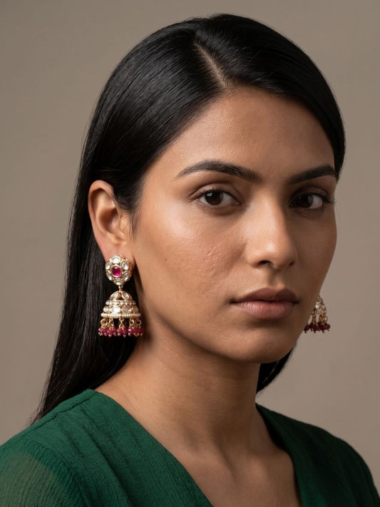 Red Kundan jhumka earrings with pearl drops, Polki and American diamond details in a gold-plated finish for wedding and festive styling.