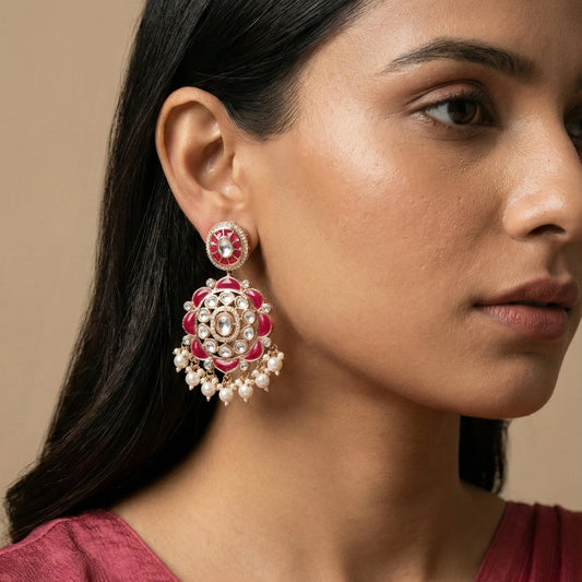 Red gold plated Kundan earrings with layered floral stonework, Polki detailing and delicate pearl drops for bridal, festive and ethnic looks.
