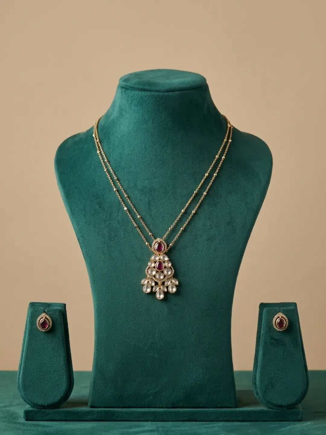 Red stone teardrop Polki pendant necklace and matching stud earrings, suitable for festive outfits, parties and traditional occasions.
