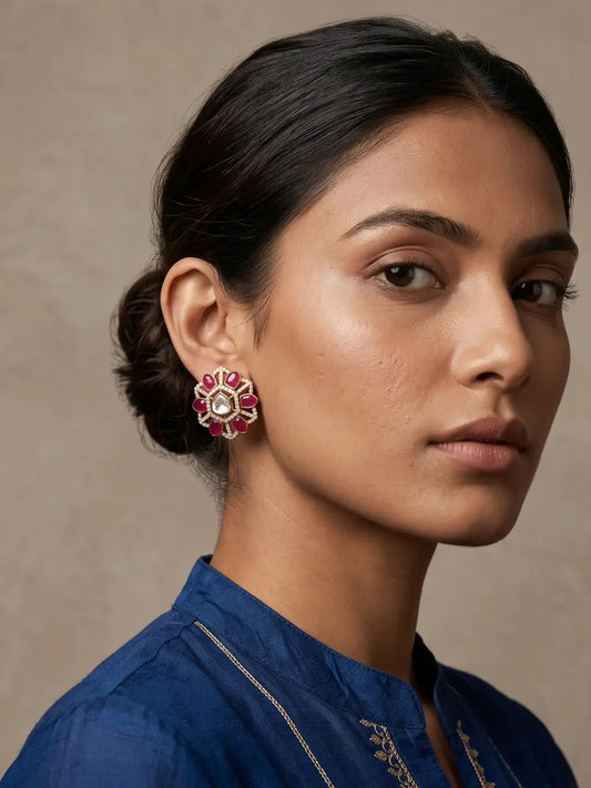 Red uncut Polki stud earrings with prominent centre stone, CZ accents and petal-shaped colour stones in a gold plated floral design