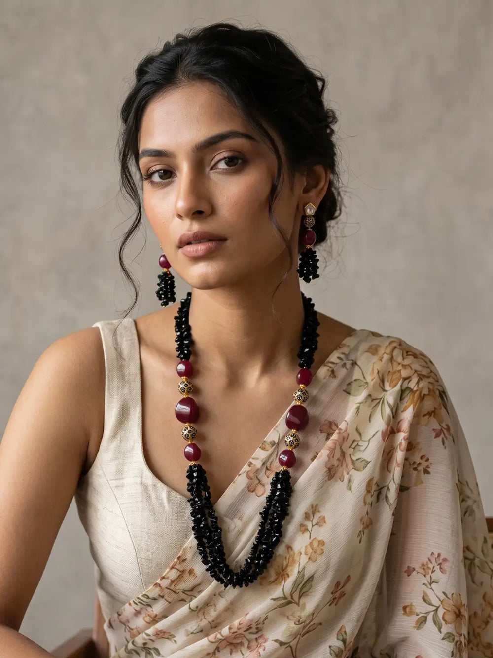 Matching drop earrings with red accents, decorative gold-tone elements and black beaded tassels, designed to coordinate with the necklace
