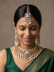 Royal blue Kundan Polki bridal jewellery set featuring a gold-plated necklace, statement earrings, matching maang tikka, CZ stones and cascading pearl drops.