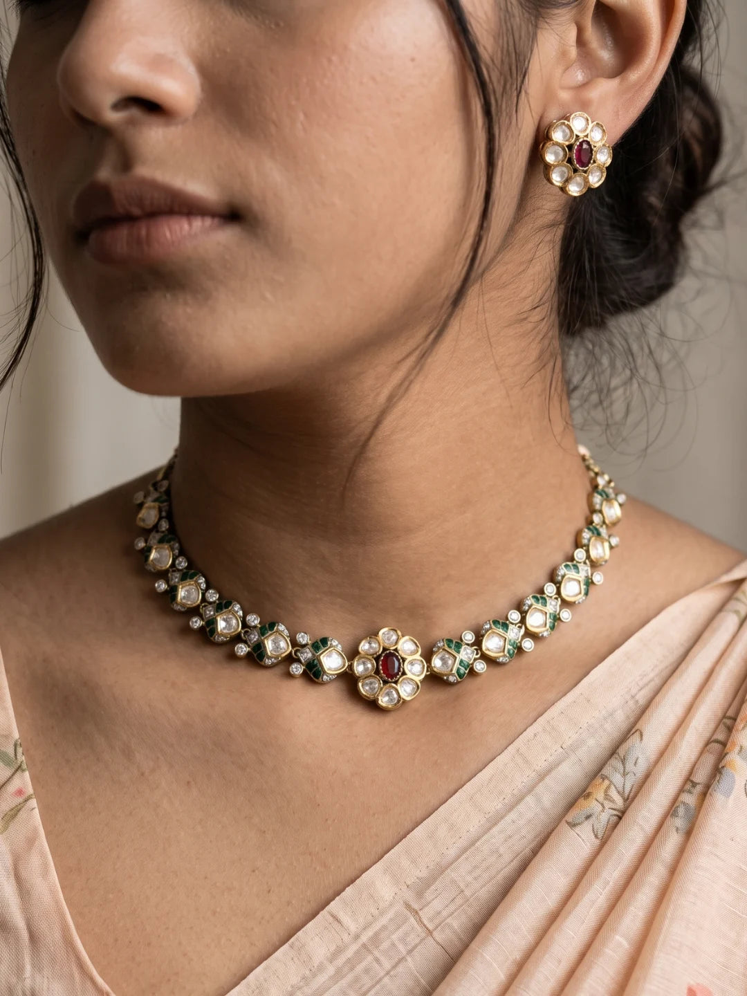 Ruby pink dual-tone Polki necklace set with a floral centrepiece, enamel detailing, clear CZ stones and matching stud earrings.