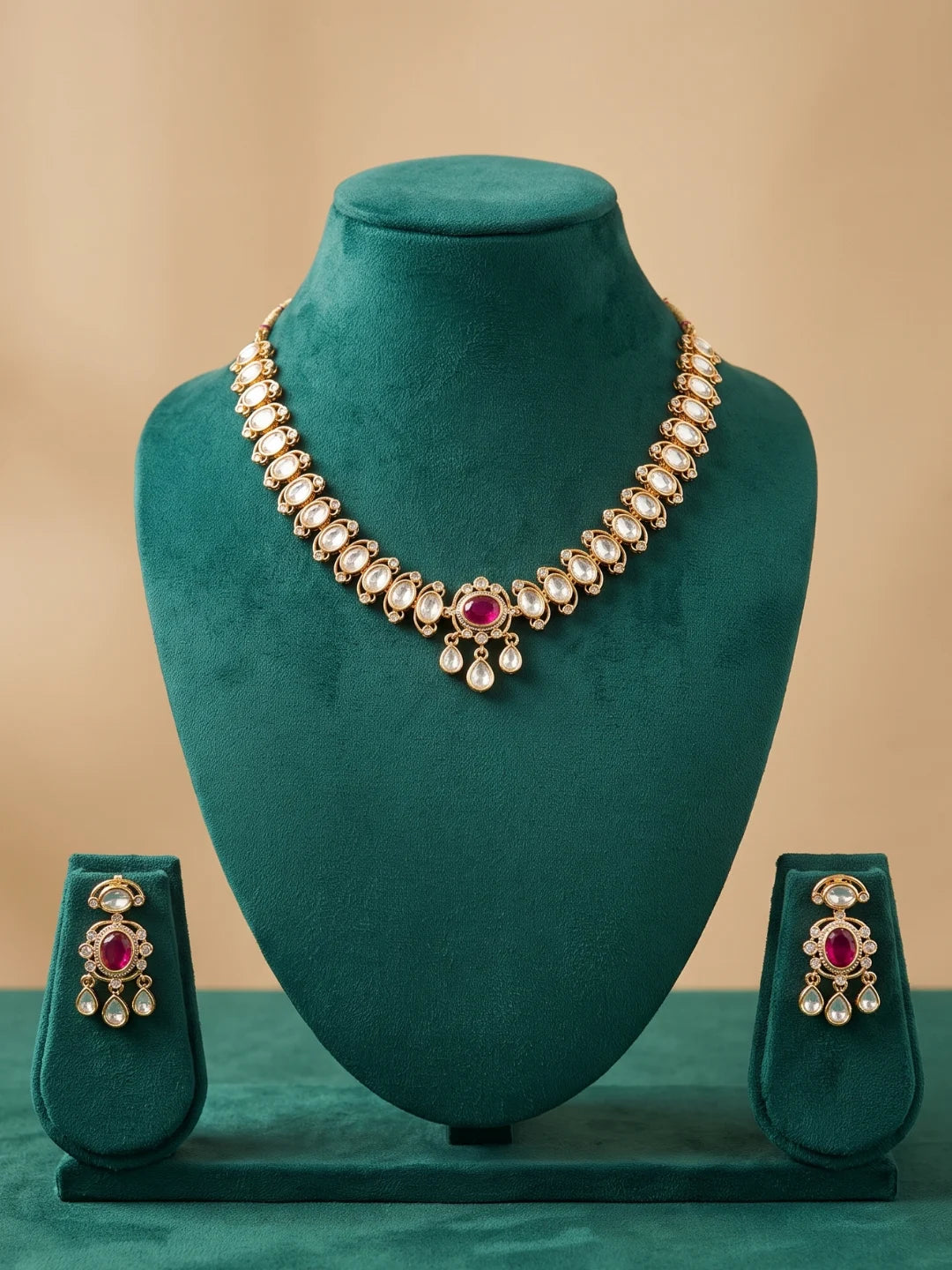Ruby pink gold-plated choker set with Polki and CZ stone accents, oval floral detailing, and matching dangler earrings for festive wedding outfits.