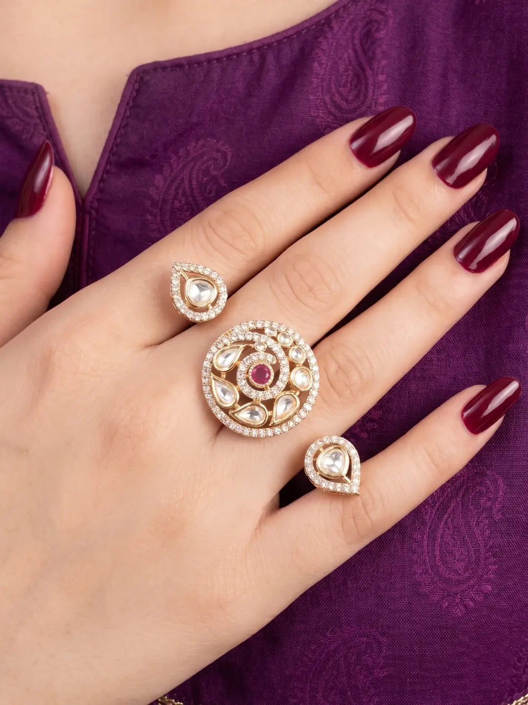 Ruby pink Kundan Polki dual finger ring with two connected gold-tone bands, floral stone clusters and CZ detailing for bridal and festive styling