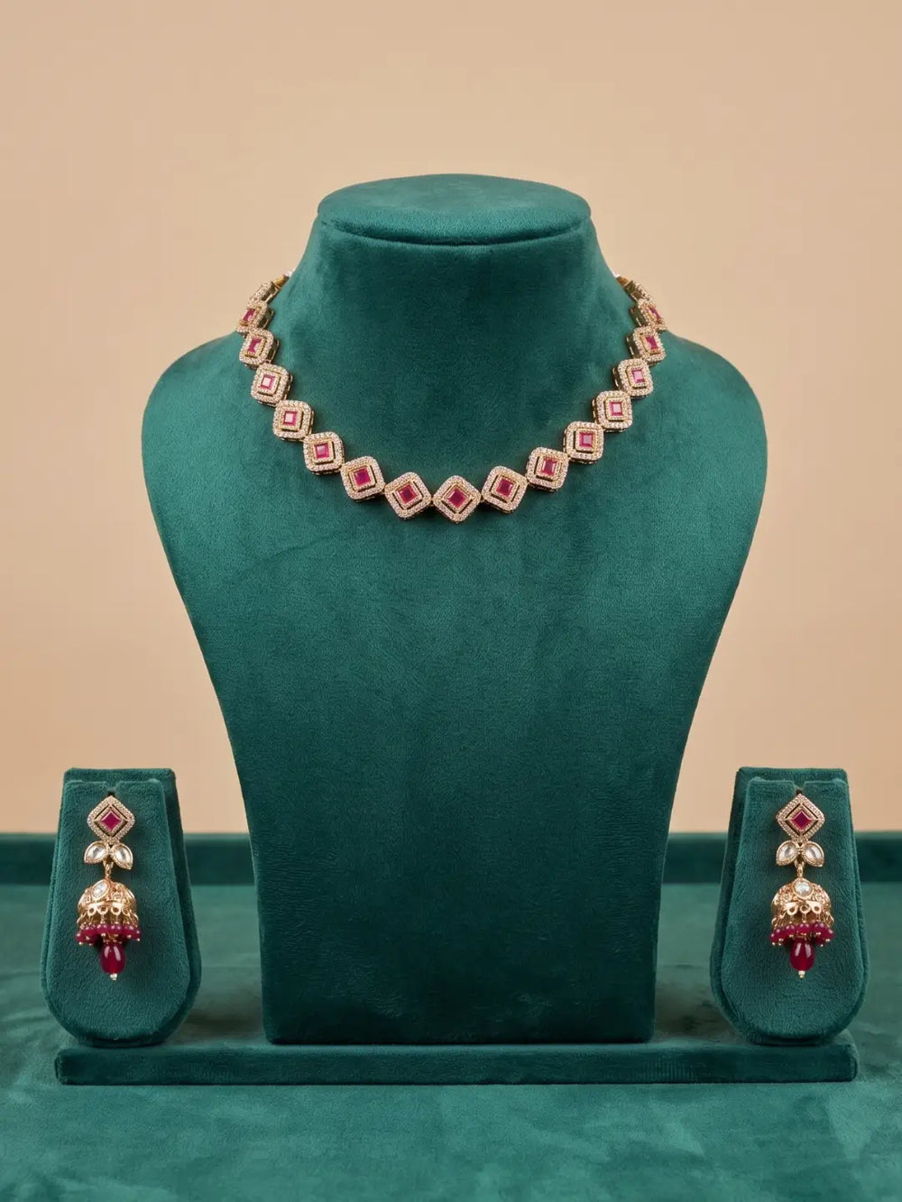 Ruby pink Polki and Kundan-style necklace featuring CZ stones with matching jhumka earrings for ethnic wedding jewellery styling.