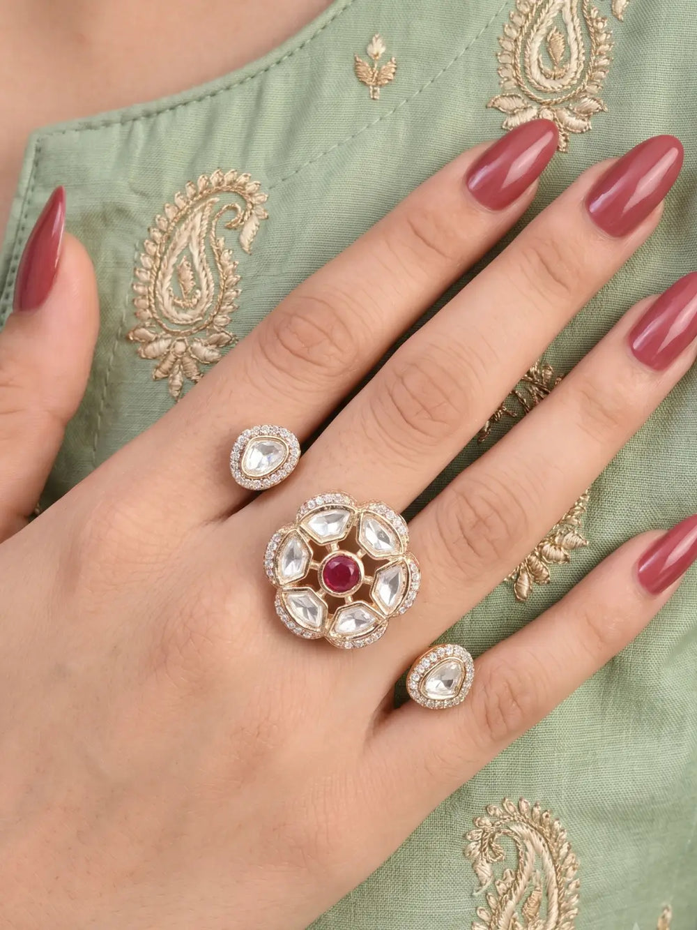 Ruby pink Polki Kundan double finger ring with two connected gold-tone bands, floral stonework and sparkling CZ details for bridal and festive styling