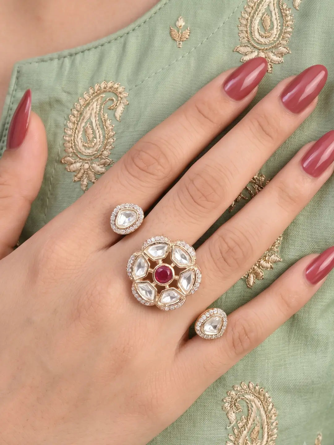 Ruby pink Polki Kundan double finger ring with two connected gold-tone bands, floral stonework and sparkling CZ details for bridal and festive styling
