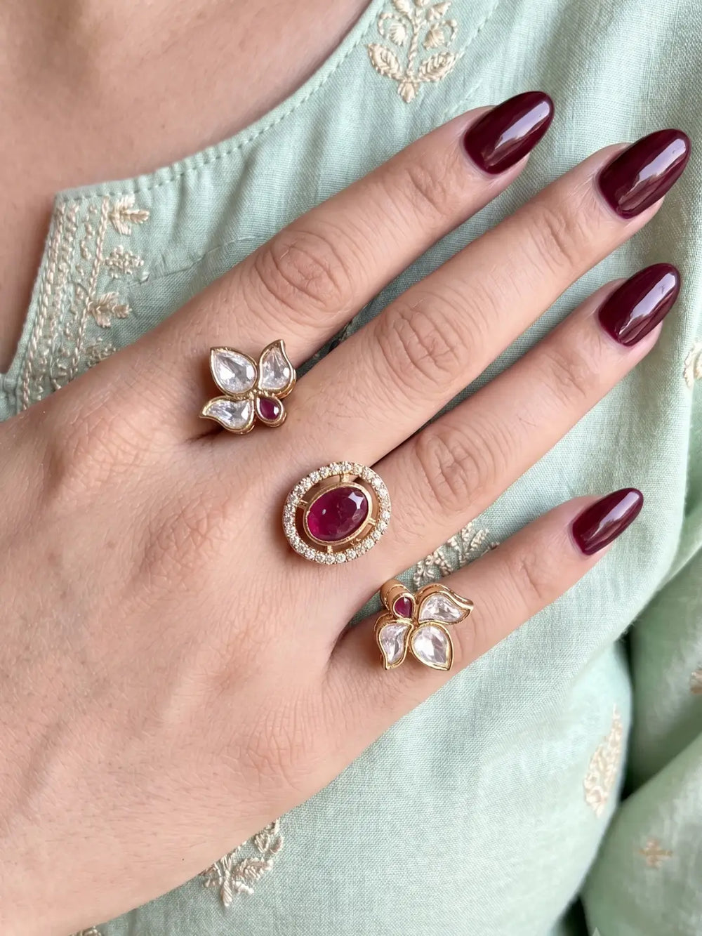 Ruby pink Polki Kundan dual finger ring with two gold-tone bands, floral clusters, pear-shaped stones and a sparkling centre for bridal and festive looks