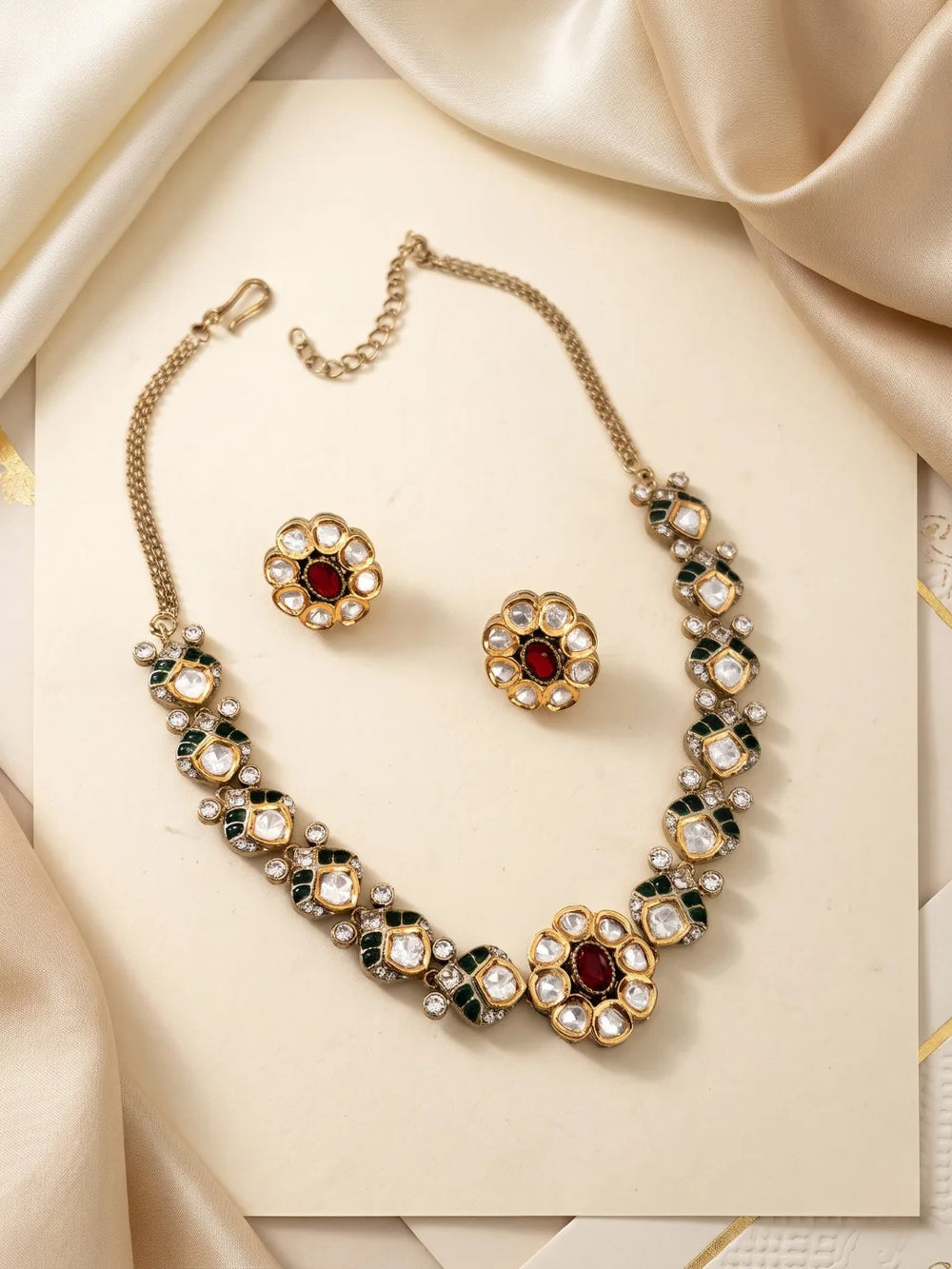 Ruby pink Polki necklace set with a decorative floral centre, dual-tone plating, coloured accents and matching statement studs.